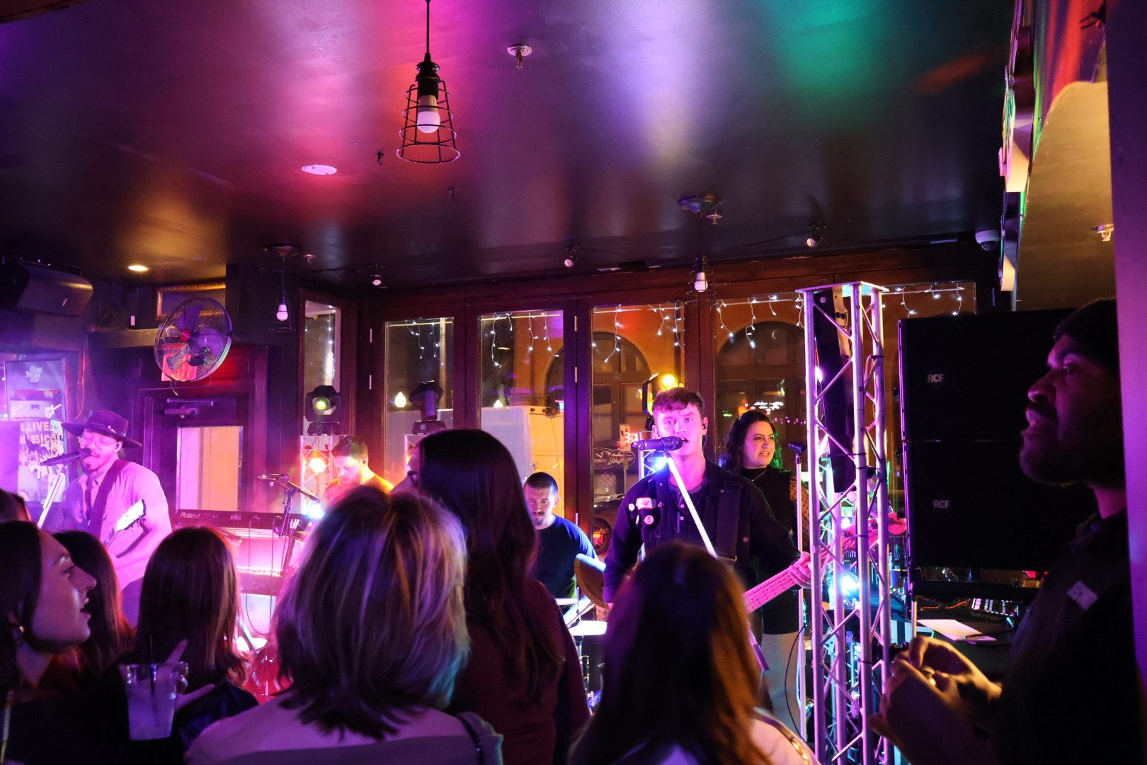 Band performing for a crowd at River Street Garage