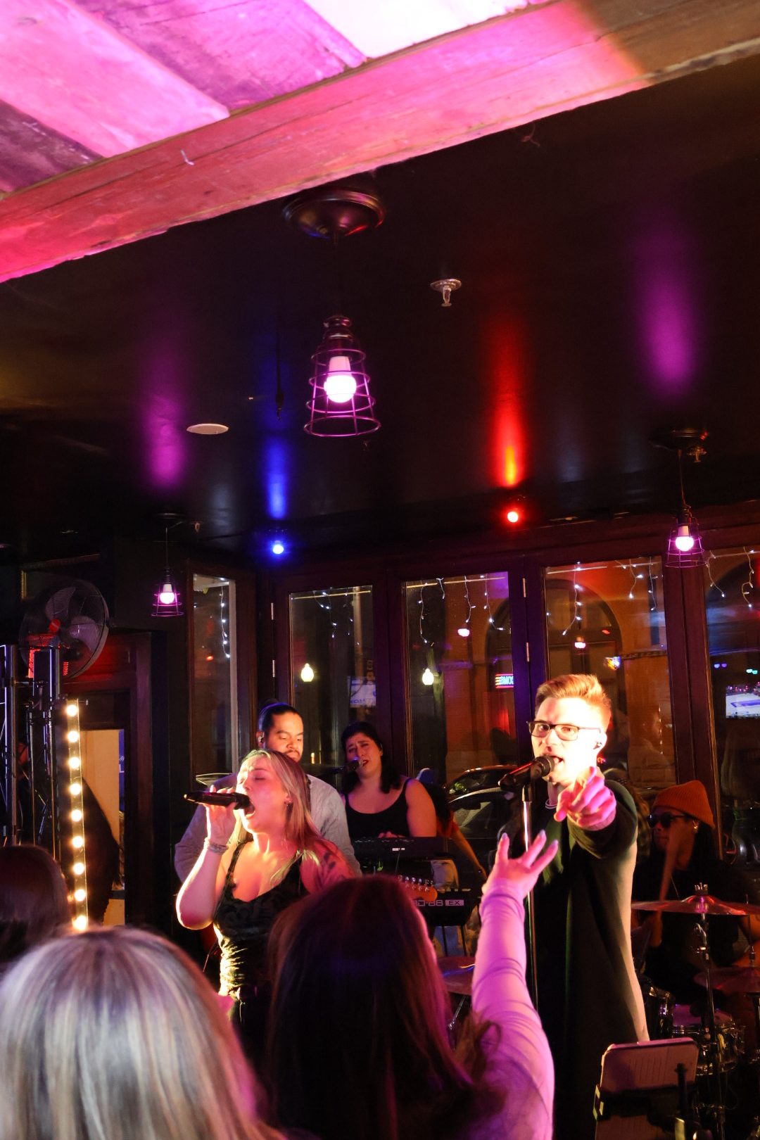 Singer and bassist performing on stage