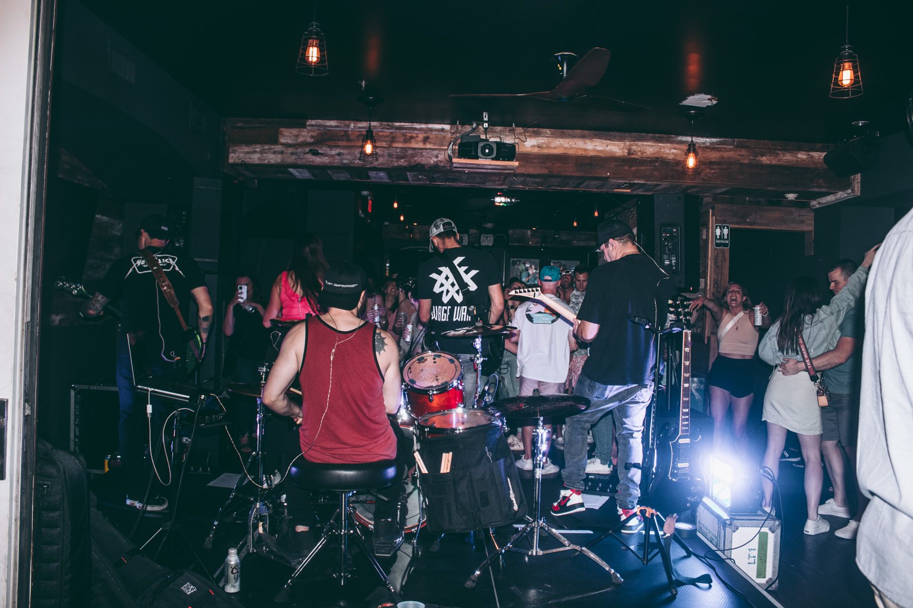 Band performing under the garage's exposed wood beams