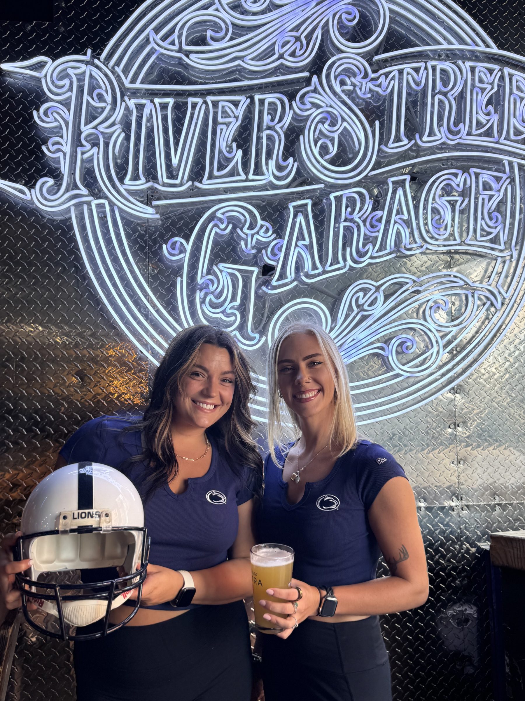 Guests in Penn State jerseys in front of the River Street Garage sign