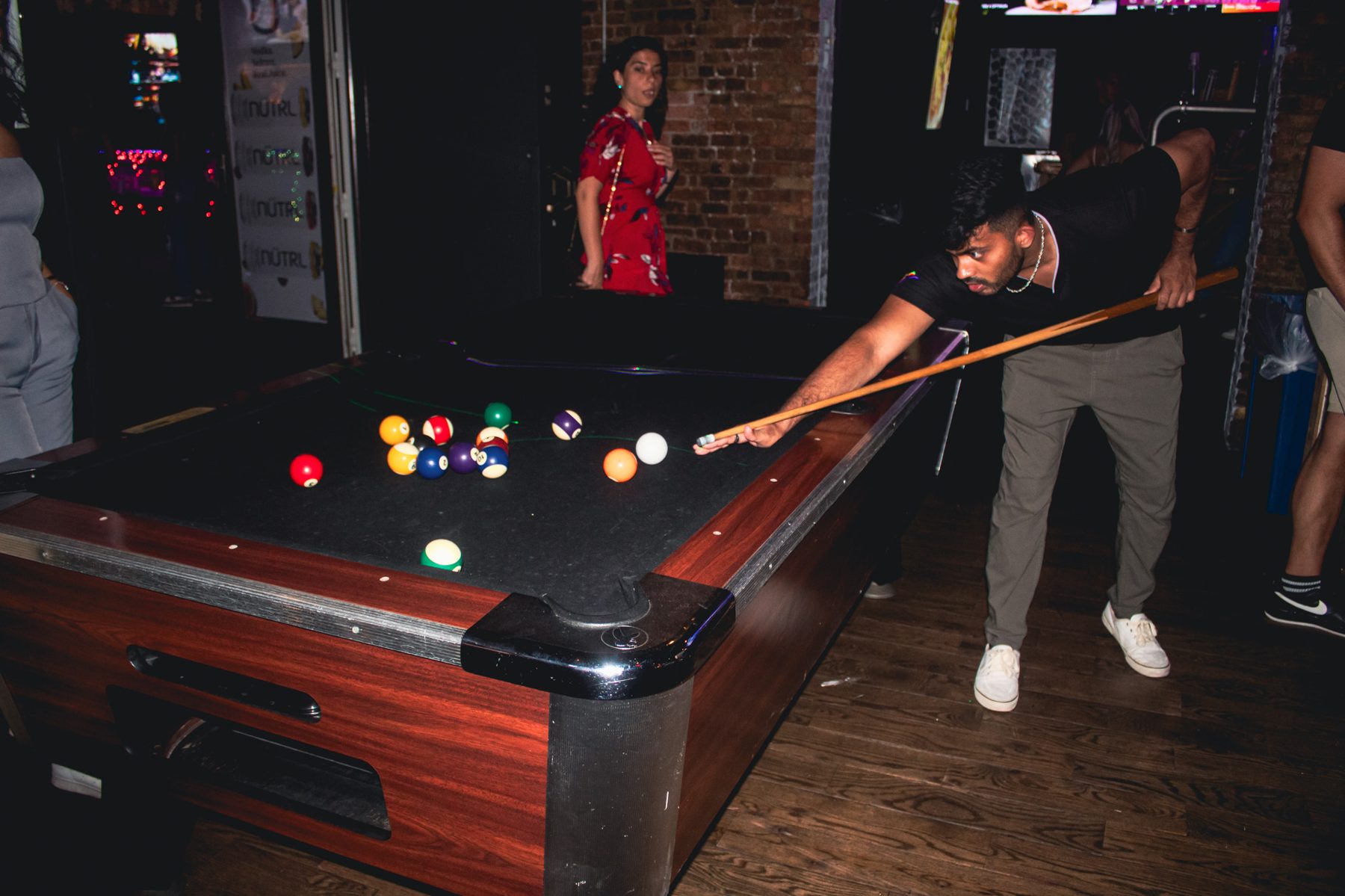 Guests playing pool at River Street Garage