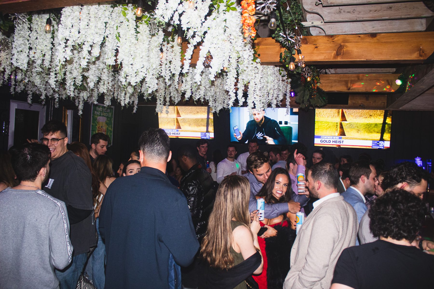 Guests under the garage's flower-lined ceiling